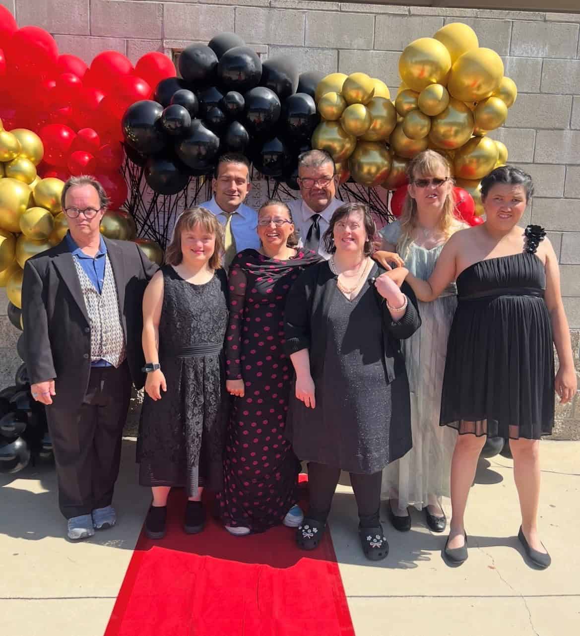 Group of people celebrating with balloons at The Arc of Ventura County event.