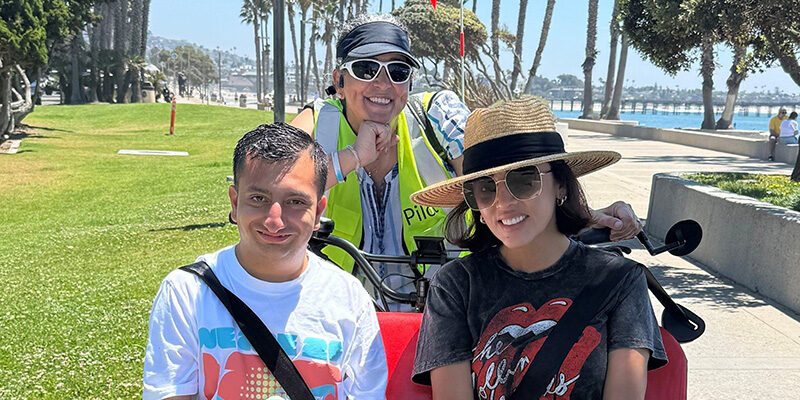 Smiling people with strollers at the park near the beach in Ventura County.